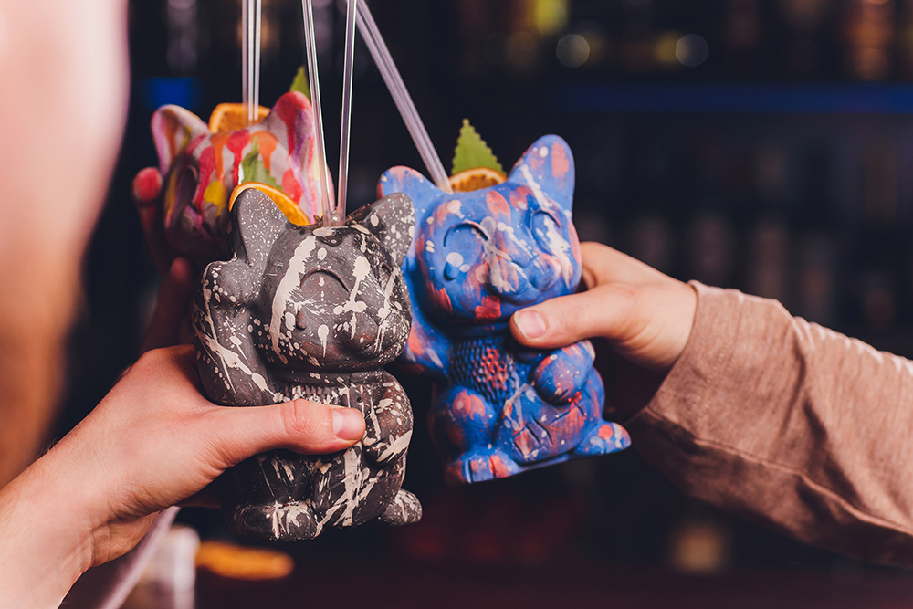 hands making good cheer of cat-themed cocktails