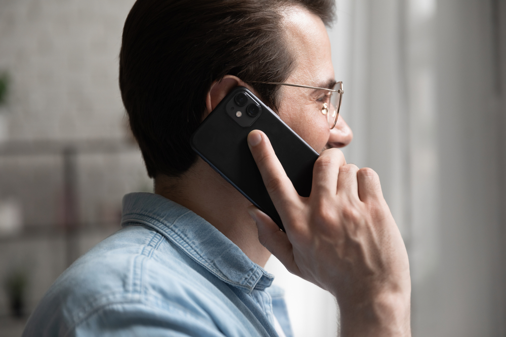 man with glasses calling on his smartphone